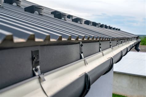 installing gutters on a house with metal roof|hidden gutter metal roof system.